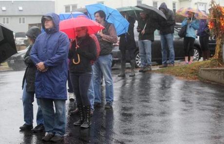 Customers waited in the wind and rain outside Owen's Poultry Farm in Needham to pick up turkeys and other items.
