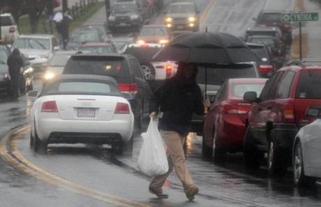 A customer crosses a busy Central Avenue in Needham after picking up his turkey.
