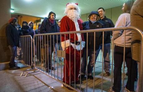 Cam Harrington, 21, of Charlestown, wore a Santa suit while waiting for Target to open its doors. 
