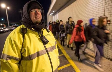 A security guard watched the line outside Target before store employees threw open the doors. 
