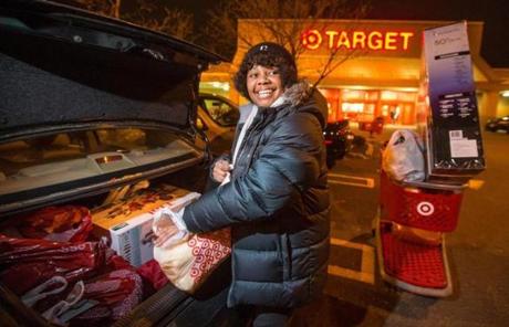 Delphine Arthur, of Cambridge, loaded her car with items she secured at Target early Friday. 
