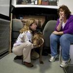 Denise Fitzmaurice (right) took her dog, Sophie, to Michele Price’s mobile veterinary clinic  in Virginia. A growing number of veterinarians have begun offering hospice care for pets.