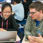 “How do we expect kids to succeed in a global economy when we don’t prioritize what’s basically 21st-century literacy?” said Bill Stitson, a software engineer at Trip Advisor, with student Ngan Ly.