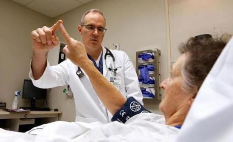 Todd Murray, 49, an emergency room doctor, examined a patient at Oregon’s Peace Harbor Hospital.
