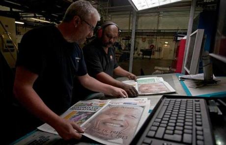 South African pressmen reviewed copies of newspapers early Friday commemorating the nation’s late leader, Nelson Mandela. 
