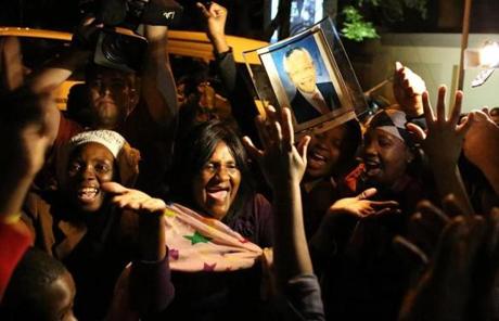 South Africans held pictures of their former president as they paid tribute to Mandela following his death late Thursday.
