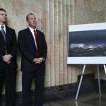 Gary Luderitz of Mohegan Gaming Advisors (left) and Chip Tuttle of Suffolk Downs at a news conference Monday in Lynn, next to a rendering of a proposed casino development.