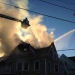 The fire broke out in a three-family home on Monmouth Street at 1:49 p.m., a fire official said.