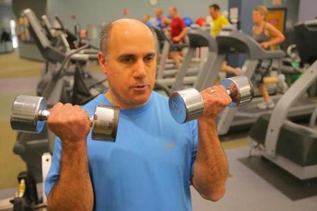 Bruce Wolfeld (top), a product manager at EMC Corp., worked out at the company’s fitness center in Hopkinton.
