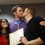 The first gay couple to be married in Utah, Michael Ferguson (second right) and his husband Seth Anderson (right), kissed after the ceremony.