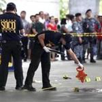 Police investigators worked at the crime scene after the mayor of Labangan and his wife were killed at the Ninoy Aquino International Airport.