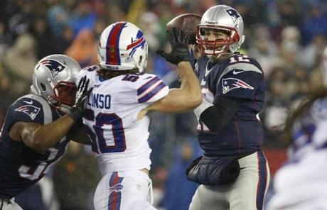 Tom Brady looked for a receiver under pressure from the Bills' Kiko Alonso.
