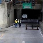 Workers at the entrance of the Callahan Tunnel on Saturday. The tunnel will be closed for repairs for three months.