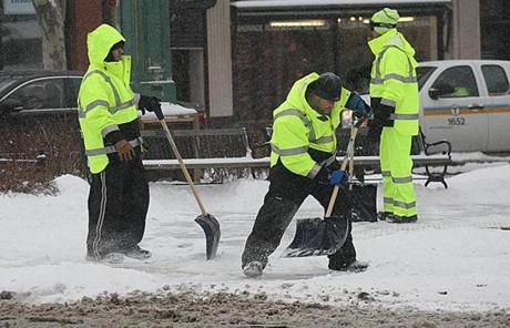 MBTA workers kept the tracks and surrounding areas clear on Beacon Street.

