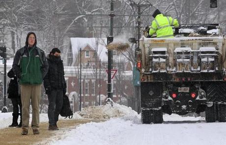 City workers dropped sand along Commonwealth Avenue in Boston.
