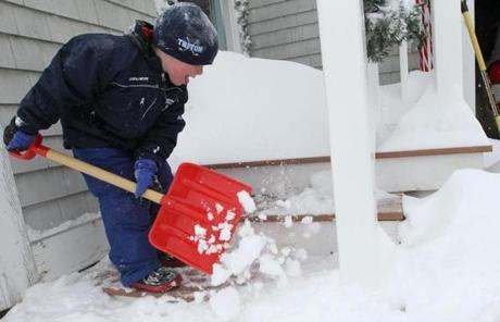 Luke Wile 6, of Ispwich helped his father shovel out from the 24 inches of snow that fell overnight.
