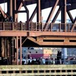 Police, fire, and other personnel were at the scene on the Meridian Street bridge after a woman was killed on Tuesday.