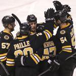Happy Bruins swarm defenseman Torey Krug after a goal, a scene seen twice during the second period.