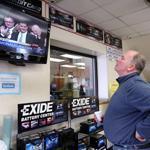 Joe Dillon, a Boston municipal employee, watched the inauguration of Martin J. Walsh at Dorchester Tire Service on Monday. City residents said they want the new mayor to be aggressive with plans to reduce crime and spur job growth.
