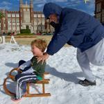 Armondo Hevia pushed his son, Emile, 7, at Loyola University in snow left over from a 12th Night snowball fight in New Orleans Tuesday. But below-freezing temperatures made life hard for some in the Big Easy.