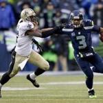 Seahawks quarterback Russell Wilson pushed back Roman Harper in the fourth quarter.