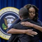 Michelle Obama embraced Bard College graduate Troy Simon at the White House meeting with college educators Thursday. Simon could not read until he was 14.
