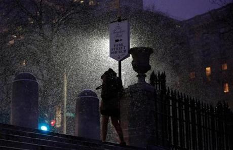 A pedestrian walked through the falling snow near Boston Common.
