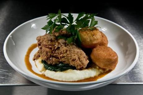 Top: Buttermilk fried chicken, served with potato puree, spinach, barbecue syrup, and plump doughnut holes. Above: the house salad board with greens, tomatoes, green beans, goat cheese, and bacon. 
