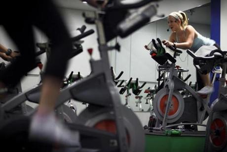 Dedicated fitness buffs powered through a spin class at Flywheel Sports, which is among the specialized studios thundering into Boston.

