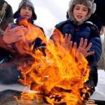 Scouts Joey McCoy, 10, and Tom Davidson, 9, kept warm by a fire they lit at Endicott Park in Danvers at the annual Klondike Derby, where about 350 youths camped out and competed in survival challenges for three days. 