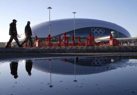 Two security personnel walked past the Bolshoy Ice Dome, site of the ice hockey competition.
