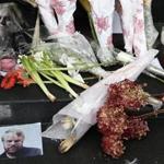 A makeshift memorial with photos and flowers was set up outside the New York City apartment building where the body of Philip Seymour Hoffman was found. 