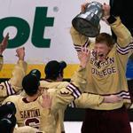 BC senior center and captain Patrick Brown hoisted the Beanpot as he was mobbed by his teammates.