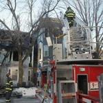 Firefighters worked the scene of a three-alarm fire on Prospect Street in Cambridge early Wednesday.