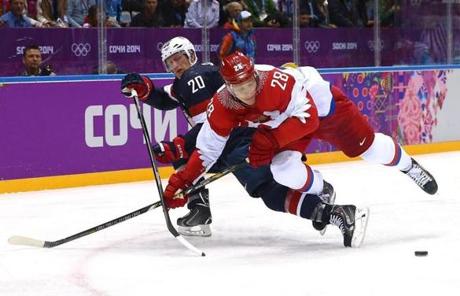 Ryan Sutter, in blue, tangled with Russia’s Alexander Syomin.

