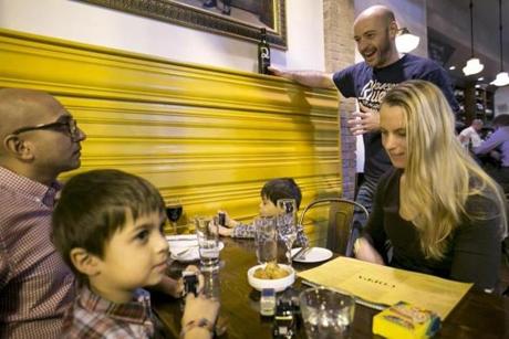 Jesse Weiss waits on Alexandra Patel and her children, Noah and Devin, at Coppa. 
