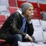 A Russian hockey fan lingers in the empty seats of Bolshoy Ice Dome after Russia lost Finland. A. (AP Photo/Julio Cortez)