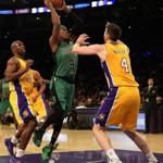 Rajon Rondo (center) went for a shot as he was defended by Ryan Kelly (right) and Jodie Meeks in the first half.