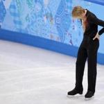 Evgeni Plushenko of Russia left the ice after pulling out of the Olympic men's short program figure skating competition. 