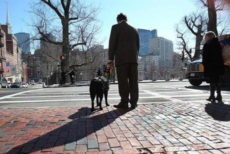 Blind and hearing-impaired, Carl Richardson stood at a crosswalk in front of the State House that has no ramp.
