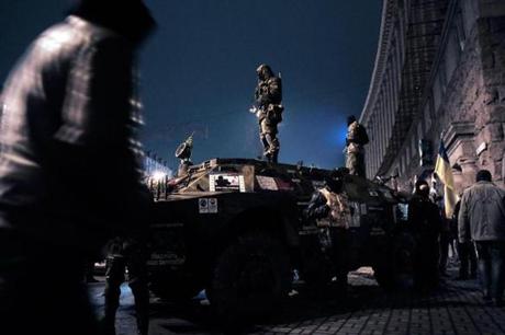 Self-defense activists stood on an armored vehicle in central Kiev on Sunday. At least 82 people, primarily protesters, were killed in clashes in Kiev last week.
