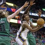 Utah’s Alec Burks (team-high 21 points) was in the middle of the Jazz’s victory, as well as between Celtics forwards Kelly Olynyk and Brandon Bass.
