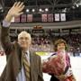 Jack Parker, who stepped down as Boston University’s hockey coach last year, waved to the student section after his number was retired during a ceremony between the first and second periods of the game against Northeastern University. Standing next to him is his wife, Jacqueline.