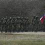 Russian soldiers walked as a local resident waved a Russian flag outside of a Ukrainian military base in the Crimean village of Perevalne.