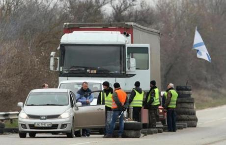 Pro-Russian people stopped and inspected vehicles on a road to Sevastopol in Crimea.
