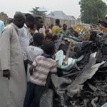 Nigerians examined the rubble Sunday after two car bombs exploded in Maiduguri the previous night.