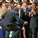 A leaping director-producer Steve McQueen celebrated with cast members after the historical drama “12 Years a Slave” was named best picture at the Academy Awards Sunday night.