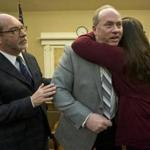 Lou Pelletier hugged his daughter Jessica after discussing the plight of his other daughter, Justina, at the State House Thursday. The Rev. Patrick Mahoney also attended the briefing. 