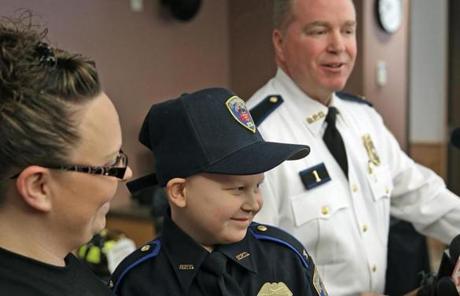 Tyler, in uniform, was joined by his proud mother, Rachel, and Burrillville police Colonel Stephen Lynch.
