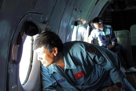 Vietnamese officials searched for the missing Malaysian plane.
